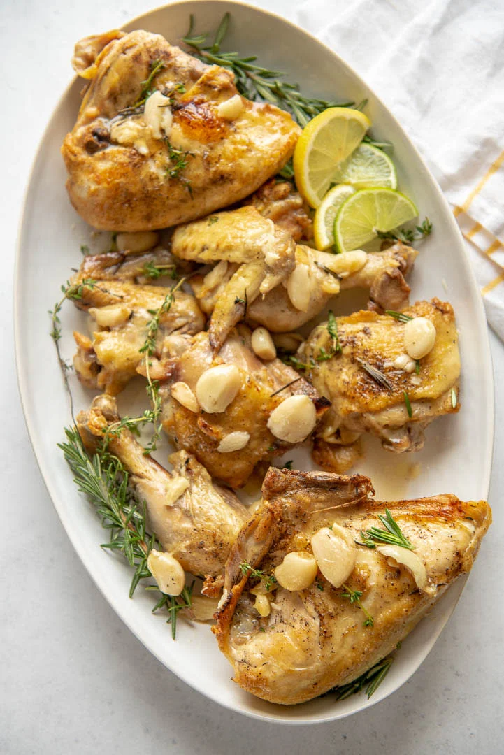 Garlic Herb Oven Roasted Chicken - This heart healthy recipe uses fresh rosemary and thyme, along with 40 cloves of garlic to make one of the best chicken dinners you'll ever eat!