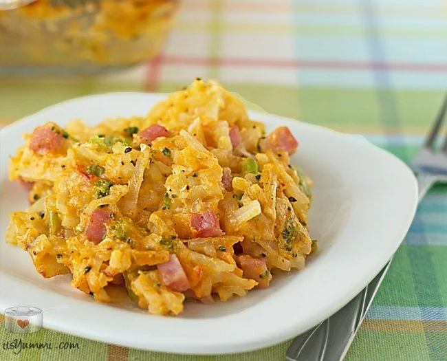 plate of hashbrown casserole with ham and cheese